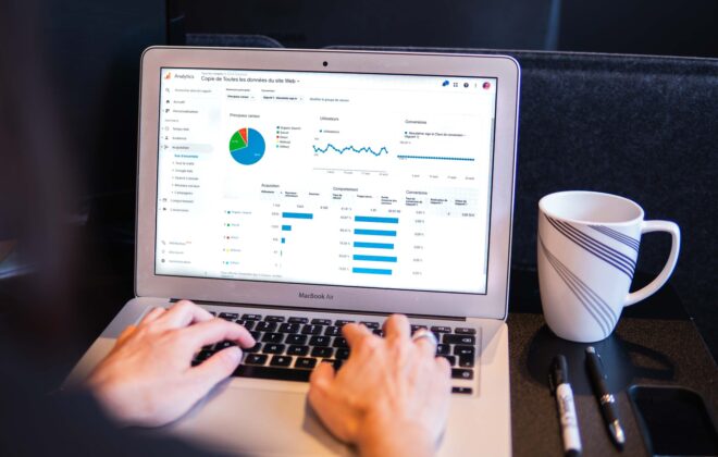 Person viewing website traffic charts on a laptop
